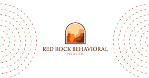 Logo for Red Rock Behavioral Health: desert canyon inside a rounded arch, brown/orange tones, with the company name beneath.